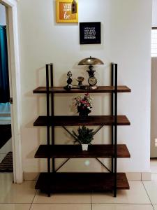 a shelf with a plant on a wall at Cozy 2BHK condo surrounded with greenery. in Mangalore