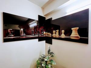 a room with chess pieces on a wall at Cozy 2BHK condo surrounded with greenery. in Mangalore