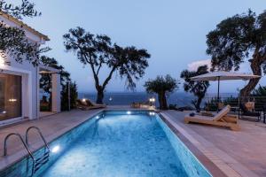 a swimming pool with a view of the ocean at Nisos Villas Corfu in Benitses