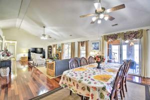 a dining room with a table and a ceiling fan at Gloucester Retreat with Backyard Oasis and Pier! in Gloucester