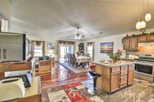 an open kitchen and living room with a table at Gloucester Retreat with Backyard Oasis and Pier! in Gloucester