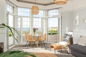 a living room with a table and chairs at A View Of The Bay- Close to Margate - Sleeps 3 in Westgate-on-Sea