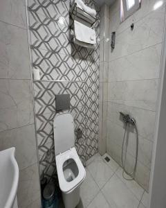 a bathroom with a white toilet and a shower at Tower352 in Melikgazi