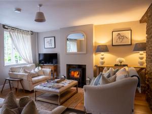 a living room with a couch and a fireplace at Stow House in Stow on the Wold