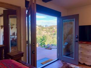 a bedroom with a sliding glass door with a view at NEW! Prickly Pear Unique Studio with bathroom built into the rocks in Prescott