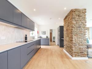 a kitchen with a stone wall and a counter top at Boscregan in Helston