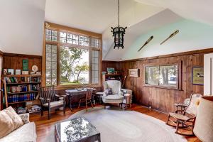 a living room filled with furniture and a table at Charming St Albans Cottage on Lake Champlain! in Melville Landing +19 photos