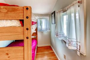 a bedroom with two bunk beds and a window at Charming St Albans Cottage on Lake Champlain! in Melville Landing