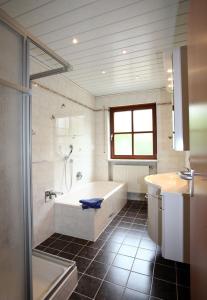 a bathroom with a tub and a shower and a sink at Ferienwohnung Singer in Schnaittach