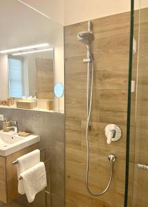 a bathroom with a shower and a sink at Palais Karl-Theodor in Rottach-Egern