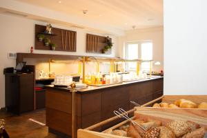 a kitchen with a counter with a bunch of bread at Ostseehotel Wustrow in Wustrow