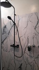 a black lamp in a bathroom with a marble wall at Holidays in Paris Loft design & atypique avec jardin in Massy