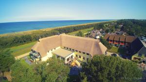 an aerial view of a large house with the ocean at Ostseehotel Wustrow in Wustrow