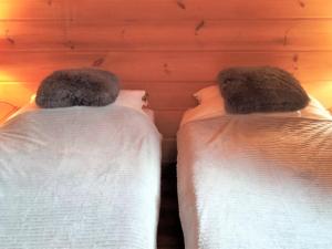 two beds sitting next to each other in a room at Chalet cosy à La Joue du Loup, piscine gratuite, 6 pers, ski à 5 min - FR-1-504-651 in Le Dévoluy