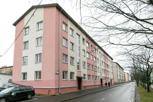 a pink and white building on the side of a street at Tallinn Randla 14 in Tallinn