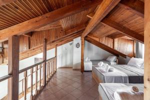 a attic room with two beds and a balcony at Blue Riviera villas & suites - Alimos 2 in Athens