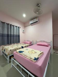a hospital room with two beds in it at บ้านคุณย่า in Rayong