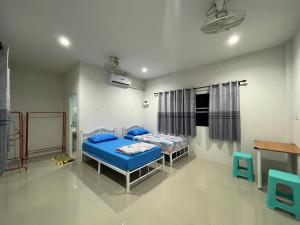 a hospital room with two beds and a table at บ้านคุณย่า in Rayong