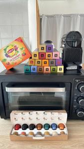 a microwave with a box of donuts on top of it at Home Up Pontoise in Pontoise