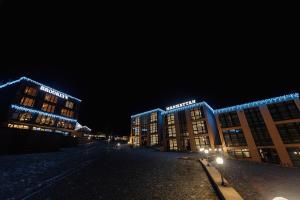 a building with blue lights on it at night at Brooklyn in Yablunytsya