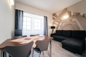 a living room with a table and chairs and a couch at Lesák rekreační středisko in Chlum u Třeboně