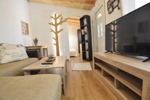 a living room with a large flat screen tv at Dream Apartment Xylokastro in Xylokastron