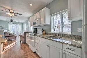 a kitchen with white cabinets and a sink at York Beachfront Condo - Steps to Long Sands! in York