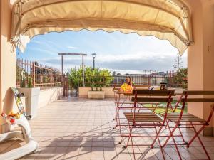 a patio with a table and chairs on a roof at Babyaccommodation Family Garden in Borgio Verezzi