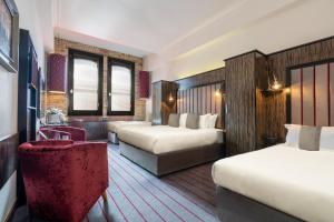Voodi või voodid majutusasutuse The Trinity City Hotel toas