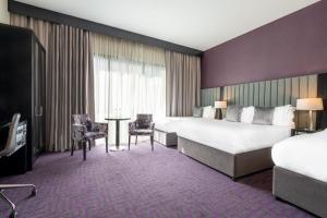 Voodi või voodid majutusasutuse The Trinity City Hotel toas