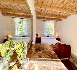 a bedroom with two beds and a table in a room at Casa Celestine in Via Orsini Isolabona Liguria Italy Sleeps 5 in Isolabona