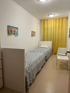 a bedroom with a bed and a table and a chair at 2 Avinguda Santa Clotilde in Lloret de Mar