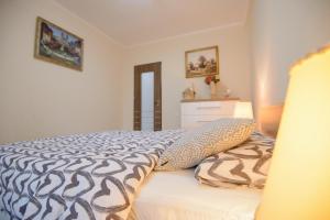 a bedroom with a bed with a blue and white comforter at Apartament Eliza in Poiana Brasov