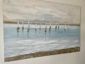 a painting of the ocean with reflections in the water at Exquisite apartment, stone throw from the beach in Bournemouth