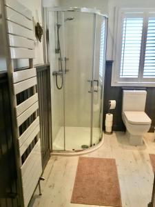a bathroom with a shower and a toilet at Firbank House in Glenrothes