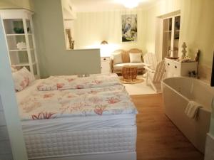 a bedroom with a bed and a bath tub at Panorama Hotel am Oberuckersee in Warnitz