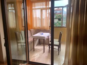 a small table and chairs in a room with a window at Hotel Rade 2 in Vratsa