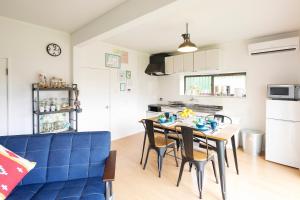 a kitchen and dining room with a table and chairs at Wave House 99 Beachside - Self Check-In Only in Kujukuri +20 photos