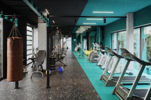 a gym with cardio equipment and treadmills at The Social Hub Barcelona Poblenou in Barcelona