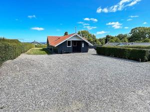 a house with a gravel driveway in front of it at 7 person holiday home in Sydals in Sarup