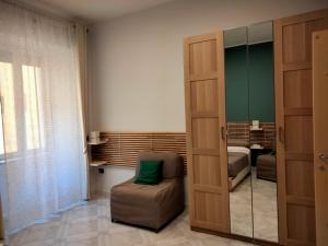 una camera con una porta scorrevole dotata di una sedia e una camera da letto di IlGirasoleApartment a Napoli