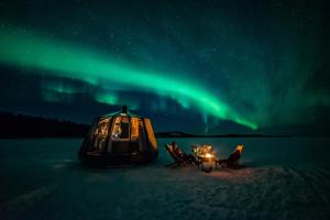 une tente dans la neige sous les feux du nord dans l'établissement Aurora hut igloo, à Rovaniemi