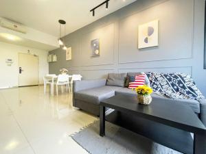 a living room with a couch and a table at Encorp Strand Lovely 2BR Condo at Kota Damansara in Petaling Jaya