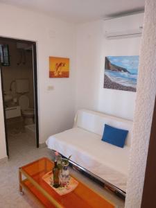 a small room with a bed and a table at Apartments Topić in Privlaka