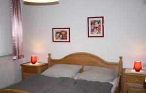 - une chambre avec un lit et 2 tables de nuit avec 2 lampes dans l'établissement Ferienwohnung Boje 6 Schillig, à Schillig