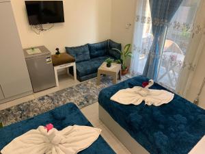 a living room with two beds and a couch at Crown Hotel in Cairo