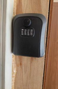 a black door handle on a wooden door at Pigeon apartment in Kuldīga