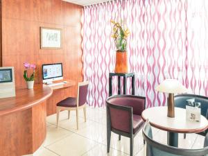 an office with a desk and chairs and a computer at Mercure Béziers in Béziers