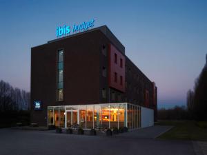 a building with a sign on top of it at ibis budget Antwerpen Port in Antwerp