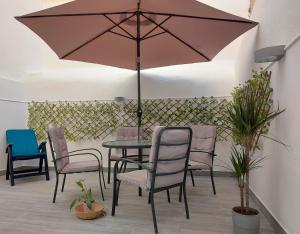 a table and chairs with an umbrella on a patio at Apartments in Central Lisbon in Lisbon